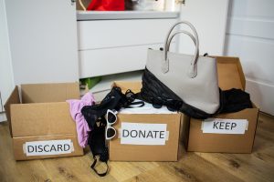 Decluttering,The,Wardrobe.,Three,Cardboard,Boxes,With,Labels,Discard,,Keep, shutterstock